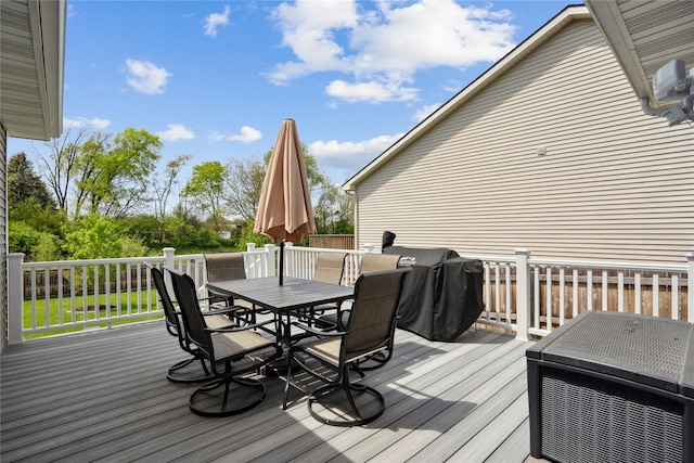 wooden terrace with outdoor dining area