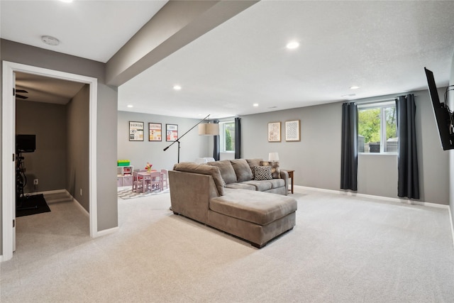 living room featuring light colored carpet, recessed lighting, and baseboards