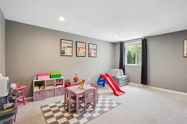playroom featuring carpet floors, a textured ceiling, recessed lighting, and baseboards