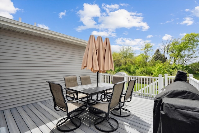 wooden deck featuring outdoor dining area