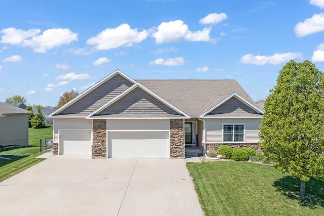 312 Evergreen Dr NW, Bondurant, IA 50035 - craftsman house featuring stone siding, an attached garage, concrete driveway, and a front yard