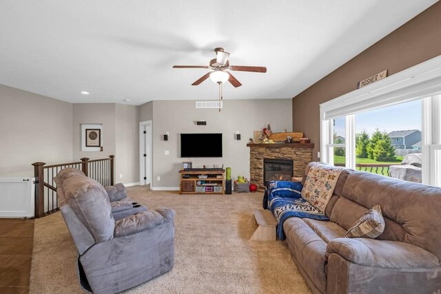 312 Evergreen Dr NW, Bondurant, IA 50035 - living area featuring ceiling fan, a stone fireplace, baseboards, and recessed lighting