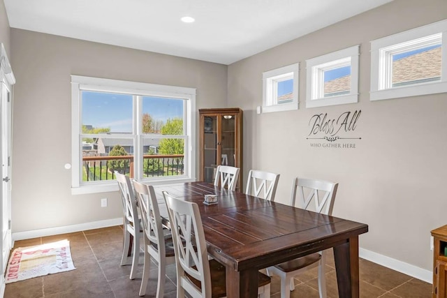 312 Evergreen Dr NW, Bondurant, IA 50035 - dining space with healthy amount of natural light, baseboards, and dark tile patterned floors