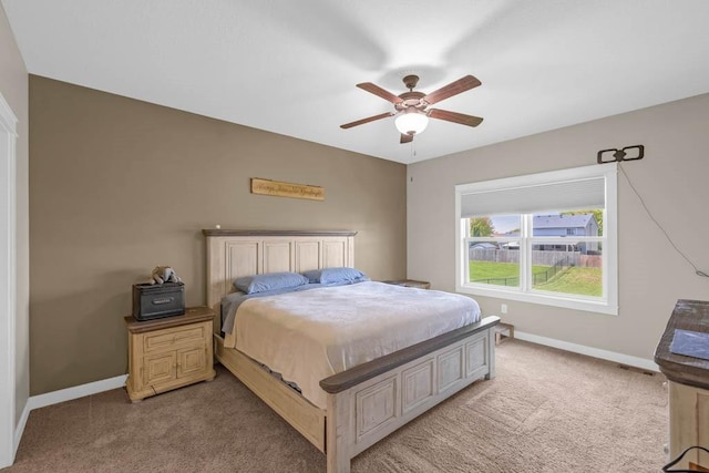 312 Evergreen Dr NW, Bondurant, IA 50035 - bedroom featuring light colored carpet, baseboards, and ceiling fan