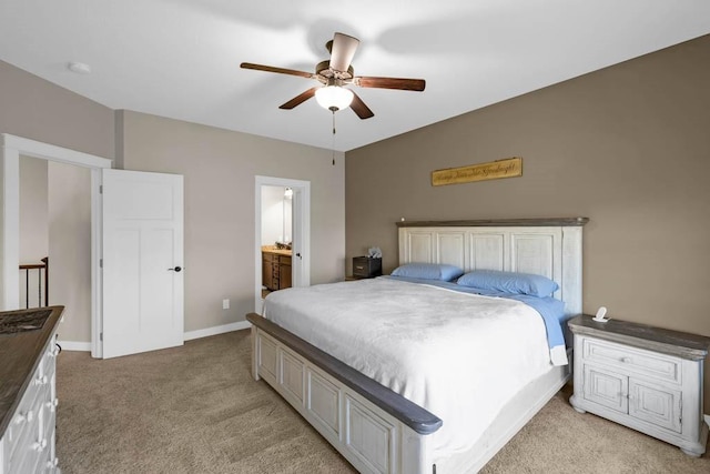 312 Evergreen Dr NW, Bondurant, IA 50035 - bedroom with light carpet, a ceiling fan, baseboards, and connected bathroom