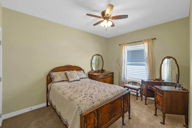 312 Evergreen Dr NW, Bondurant, IA 50035 - bedroom with light colored carpet, baseboards, and ceiling fan