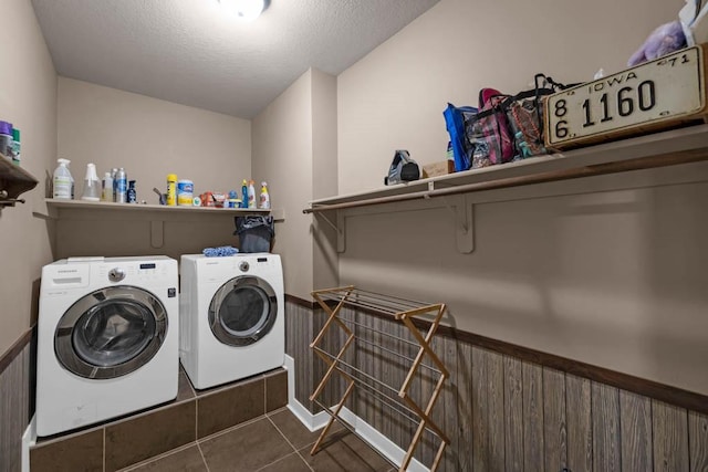 312 Evergreen Dr NW, Bondurant, IA 50035 - washroom with separate washer and dryer, dark tile patterned flooring, and a textured ceiling