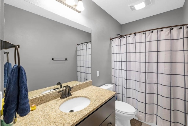 312 Evergreen Dr NW, Bondurant, IA 50035 - bathroom with toilet, vanity, curtained shower, and wood finished floors