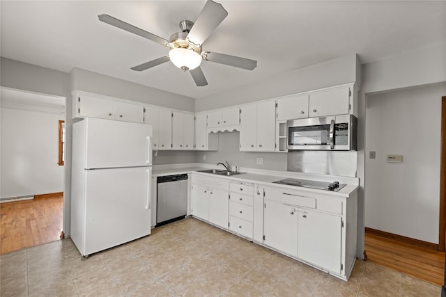 kitchen with stainless steel appliances, a sink, light countertops, and ceiling fan