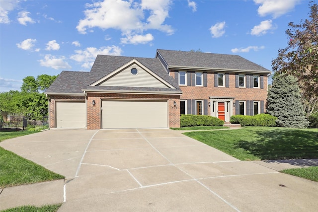 409 Stone Cir, West Des Moines, IA 50265 - colonial home featuring brick siding, a garage, driveway, and a front yard