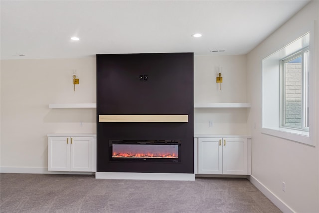 3943 NW 181st St, Clive, IA 50325 - unfurnished living room with a glass covered fireplace, light colored carpet, recessed lighting, and baseboards