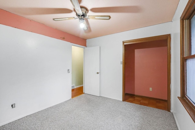 2226 Idaho Dr, Pella, IA 50219 - unfurnished bedroom with carpet and a ceiling fan