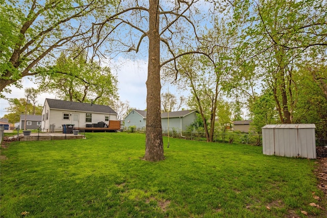 2012 61st St, Des Moines, IA 50322 - view of yard featuring a shed, a wooden deck, and an outbuilding
