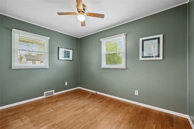 2012 61st St, Des Moines, IA 50322 - unfurnished room featuring ornamental molding, baseboards, wood finished floors, and ceiling fan