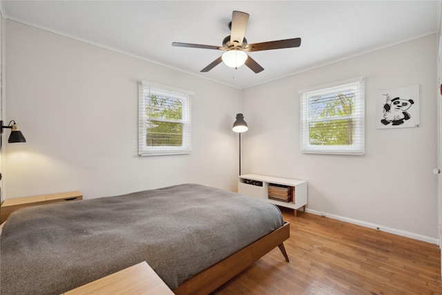 2012 61st St, Des Moines, IA 50322 - bedroom featuring light wood-style floors, baseboards, crown molding, and ceiling fan