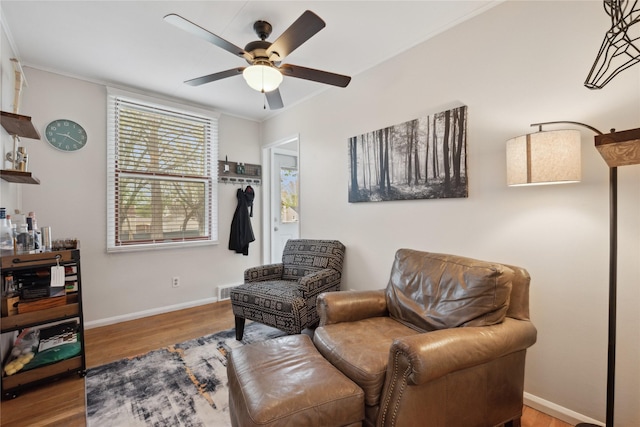 2012 61st St, Des Moines, IA 50322 - sitting room with wood finished floors, ceiling fan, and baseboards