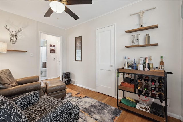 2012 61st St, Des Moines, IA 50322 - living room with ceiling fan, wood finished floors, crown molding, and baseboards