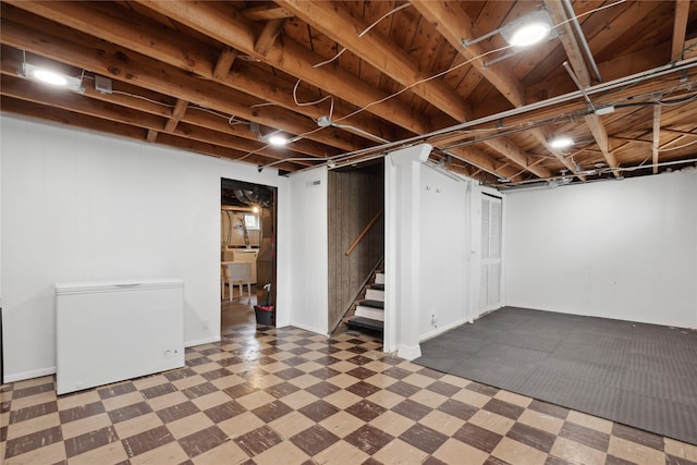 2012 61st St, Des Moines, IA 50322 - finished below grade area featuring refrigerator, tile patterned floors, and stairway