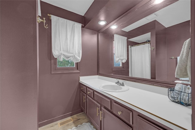 full bath with vanity, wood finished floors, baseboards, recessed lighting, and curtained shower