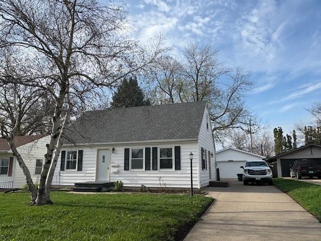 1604 Elder Dr, Marshalltown, IA 50158 - cape cod-style house featuring a detached garage, a front yard, and an outdoor structure