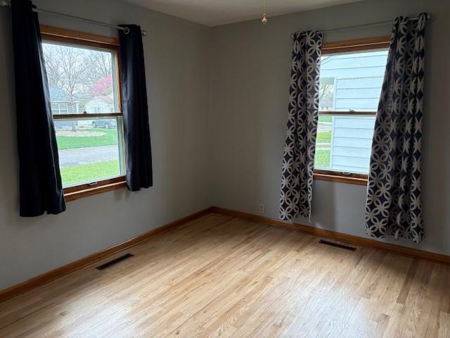 1604 Elder Dr, Marshalltown, IA 50158 - spare room featuring light wood-style flooring, healthy amount of natural light, and baseboards