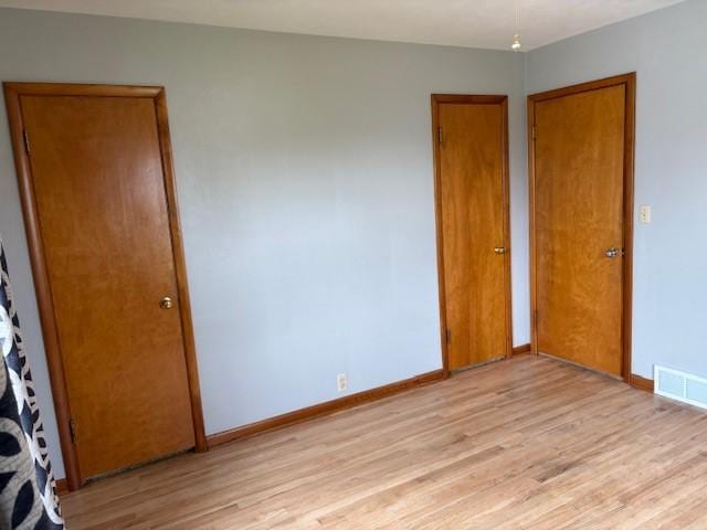 1604 Elder Dr, Marshalltown, IA 50158 - unfurnished bedroom with light wood finished floors and baseboards