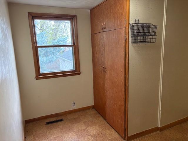 1604 Elder Dr, Marshalltown, IA 50158 - unfurnished bedroom with light floors, a closet, and baseboards