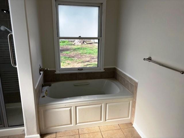 1604 Elder Dr, Marshalltown, IA 50158 - full bath with a bath, a shower stall, and tile patterned flooring
