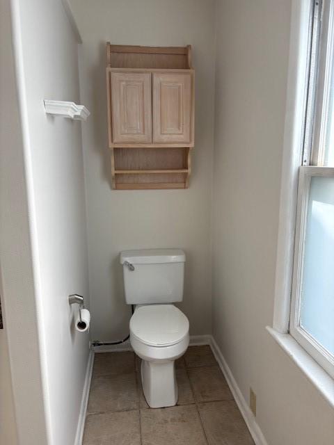 1604 Elder Dr, Marshalltown, IA 50158 - bathroom with toilet, tile patterned flooring, and baseboards