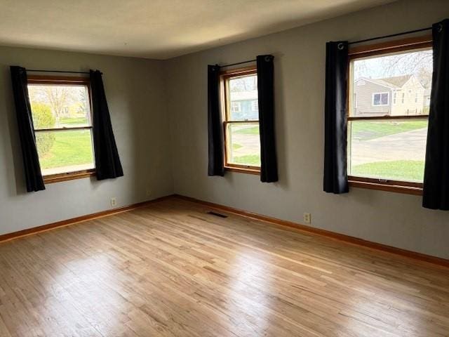 1604 Elder Dr, Marshalltown, IA 50158 - spare room with healthy amount of natural light, light wood-type flooring, and baseboards