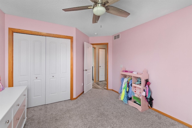 playroom featuring carpet, baseboards, and a ceiling fan