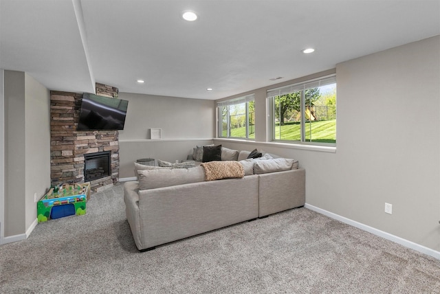 living room with carpet flooring, recessed lighting, baseboards, and a fireplace