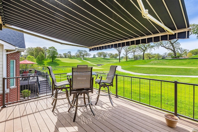 1914 Park Ave, Des Moines, IA 50315 - deck with outdoor dining area, view of golf course, and a yard