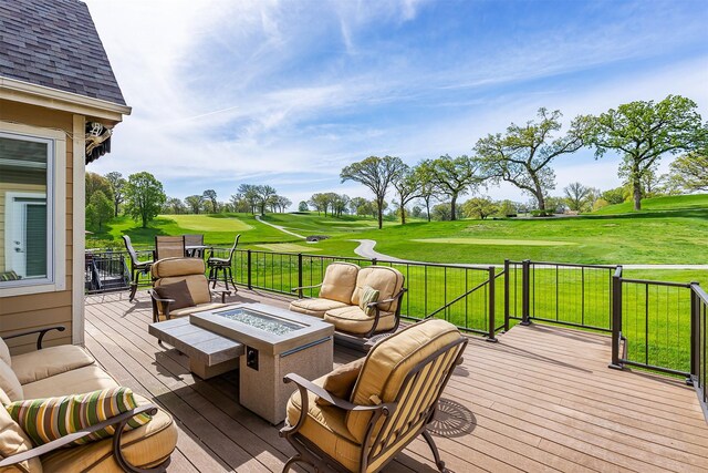 1914 Park Ave, Des Moines, IA 50315 - deck featuring golf course view, a lawn, and an outdoor living space with a fire pit