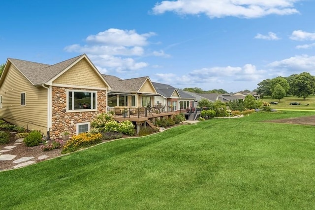 1914 Park Ave, Des Moines, IA 50315 - rear view of property with stone siding, a wooden deck, and a lawn