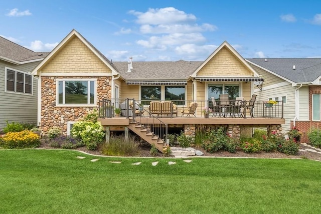 1914 Park Ave, Des Moines, IA 50315 - rear view of house featuring stone siding, a wooden deck, a yard, stairway, and a shingled roof