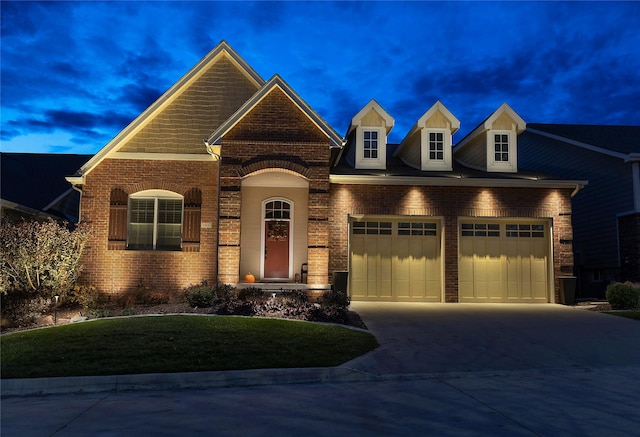 1914 Park Ave, Des Moines, IA 50315 - view of front of home with brick siding, a garage, concrete driveway, and a front lawn