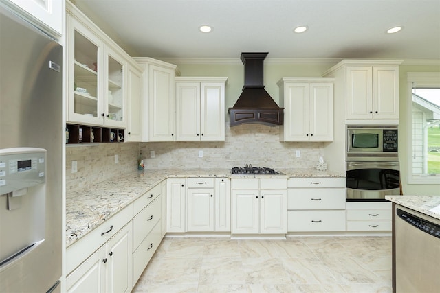 1914 Park Ave, Des Moines, IA 50315 - kitchen with stainless steel appliances, custom exhaust hood, crown molding, light stone countertops, and glass insert cabinets