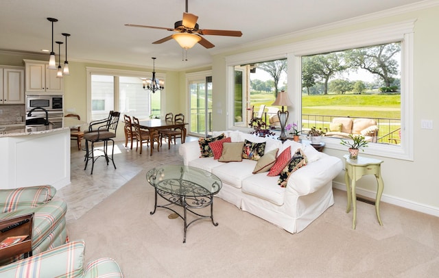 1914 Park Ave, Des Moines, IA 50315 - living area with ornamental molding, healthy amount of natural light, ceiling fan, a chandelier, and light marble finish flooring
