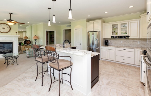 1914 Park Ave, Des Moines, IA 50315 - kitchen featuring stainless steel fridge, ceiling fan, ornamental molding, recessed lighting, and open floor plan