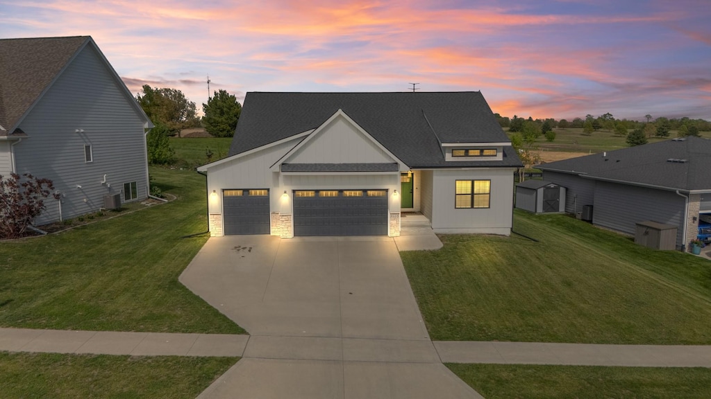 1114 Warrior Run Dr, Norwalk, IA 50211 - modern inspired farmhouse featuring concrete driveway, an attached garage, a yard, and a shingled roof