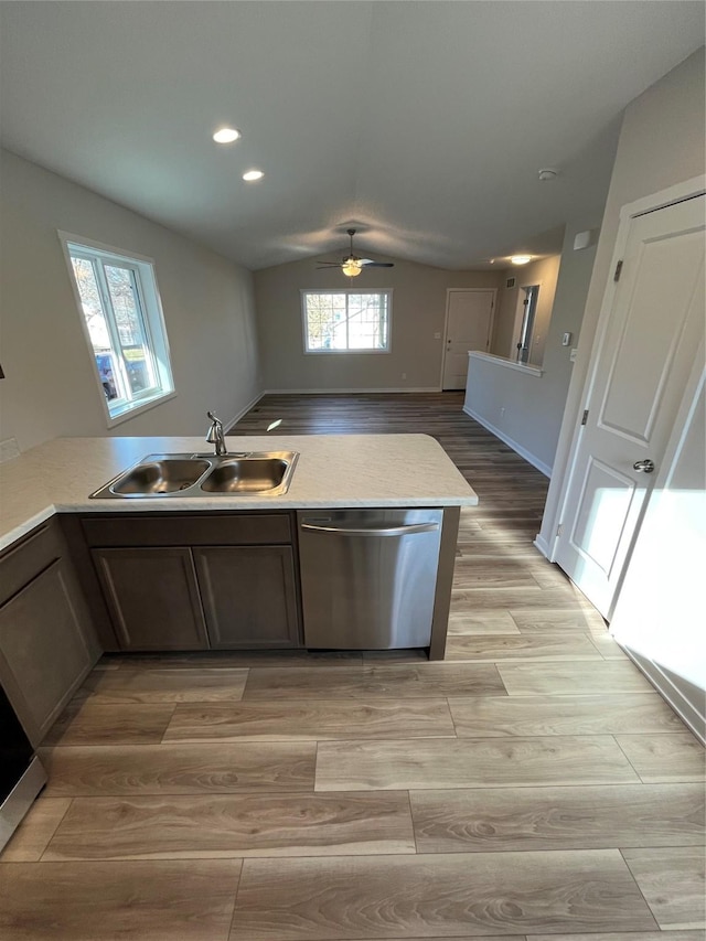 1533 Walker St, Des Moines, IA 50316 - kitchen with dishwasher, a sink, light wood-style floors, ceiling fan, and lofted ceiling