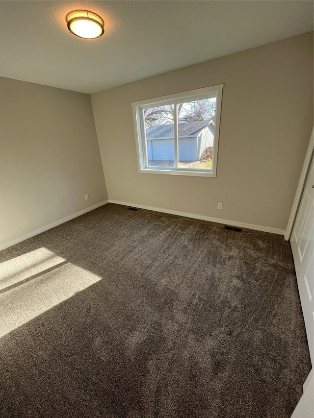 1533 Walker St, Des Moines, IA 50316 - spare room featuring dark colored carpet and baseboards