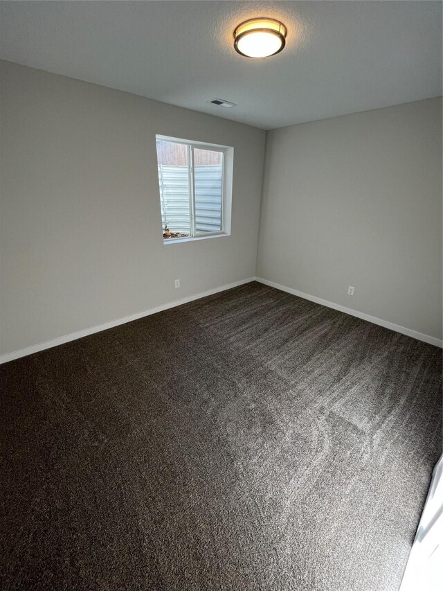 1533 Walker St, Des Moines, IA 50316 - unfurnished room featuring dark colored carpet and baseboards