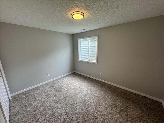 1533 Walker St, Des Moines, IA 50316 - carpeted spare room with baseboards and a textured ceiling