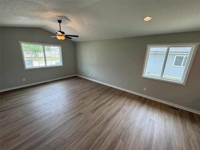 1533 Walker St, Des Moines, IA 50316 - unfurnished room with a textured ceiling, dark wood-style floors, a ceiling fan, and vaulted ceiling