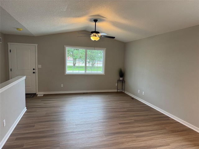 1533 Walker St, Des Moines, IA 50316 - unfurnished room featuring ceiling fan, dark wood-style flooring, a textured ceiling, and vaulted ceiling