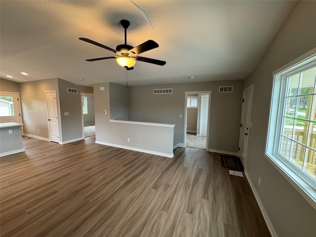 1533 Walker St, Des Moines, IA 50316 - unfurnished living room with dark wood-type flooring, a ceiling fan, and recessed lighting