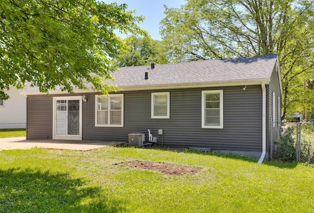 rear view of property featuring a patio, central AC, and roof with shingles