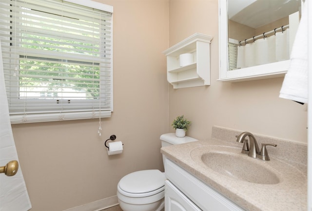bathroom featuring toilet and vanity